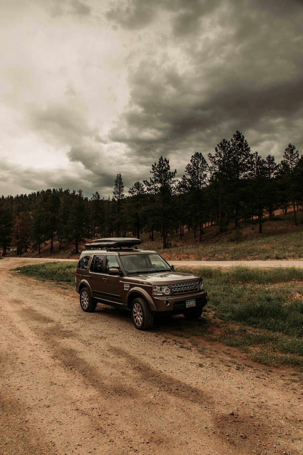 a vehicle is parked on a dirt road