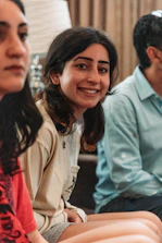 A mentor and a young girl sharing a warm conversation in a cozy setting.