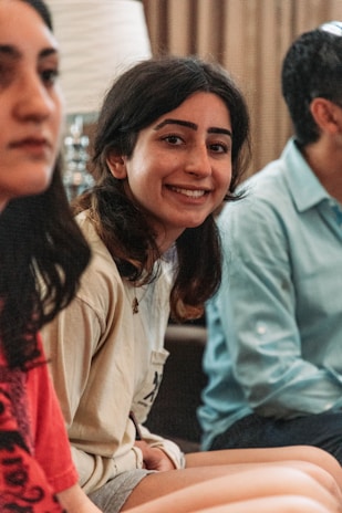 A smiling young woman engaging with local residents.