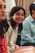 A candid photo of a woman smiling warmly during a small group gathering in a cozy mountain cabin.