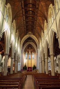 a church with pews and stained glass windows