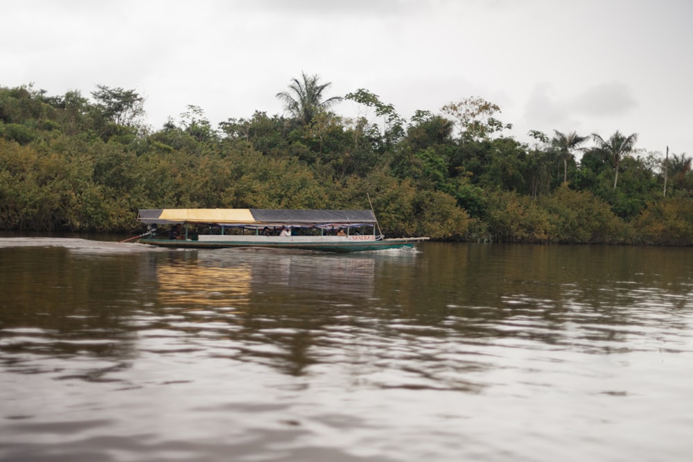 a long boat with people on it in a body of water