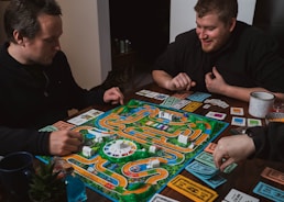 two men playing a game of monopoly on a table