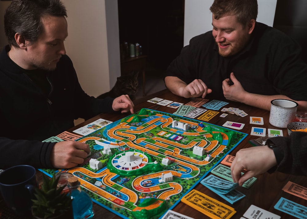 two men playing a game of monopoly on a table
