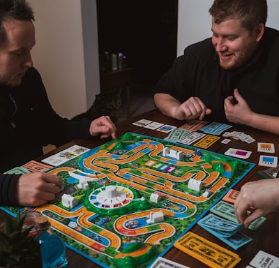 two men playing a game of monopoly on a table