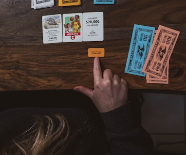 a person sitting at a table with some cards on it