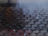 Close-up of a greasy kitchen grill before and after cleaning with Be Clean.