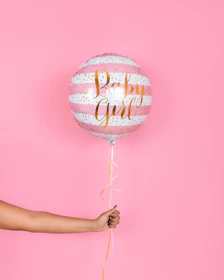 A close-up of a personalised balloon backdrop with subtle floral accents, capturing the refined luxury of a Liverpool baby shower.