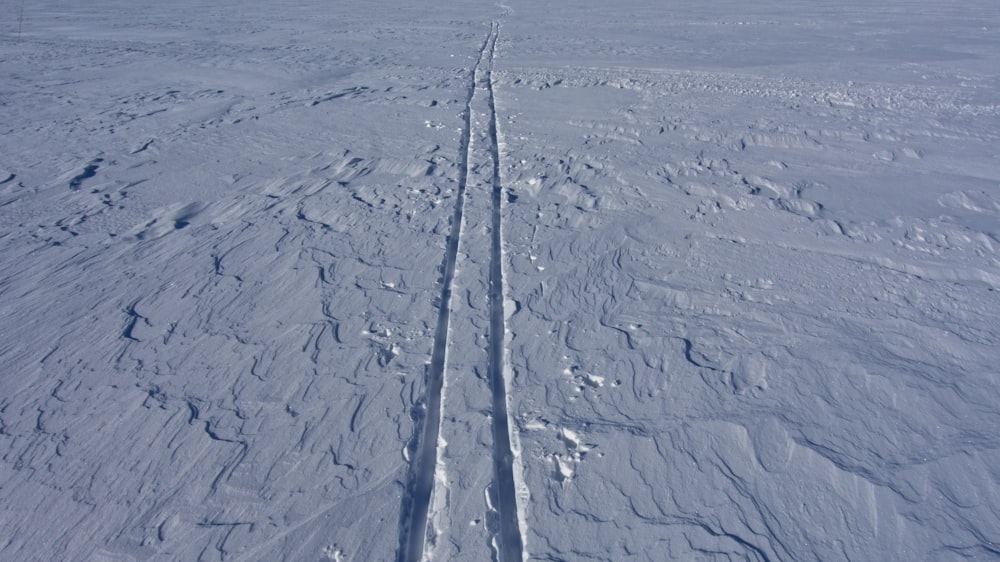 a person riding skis on a snowy surface