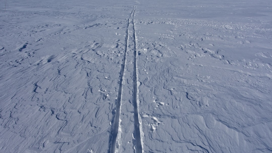 a person riding skis on a snowy surface,