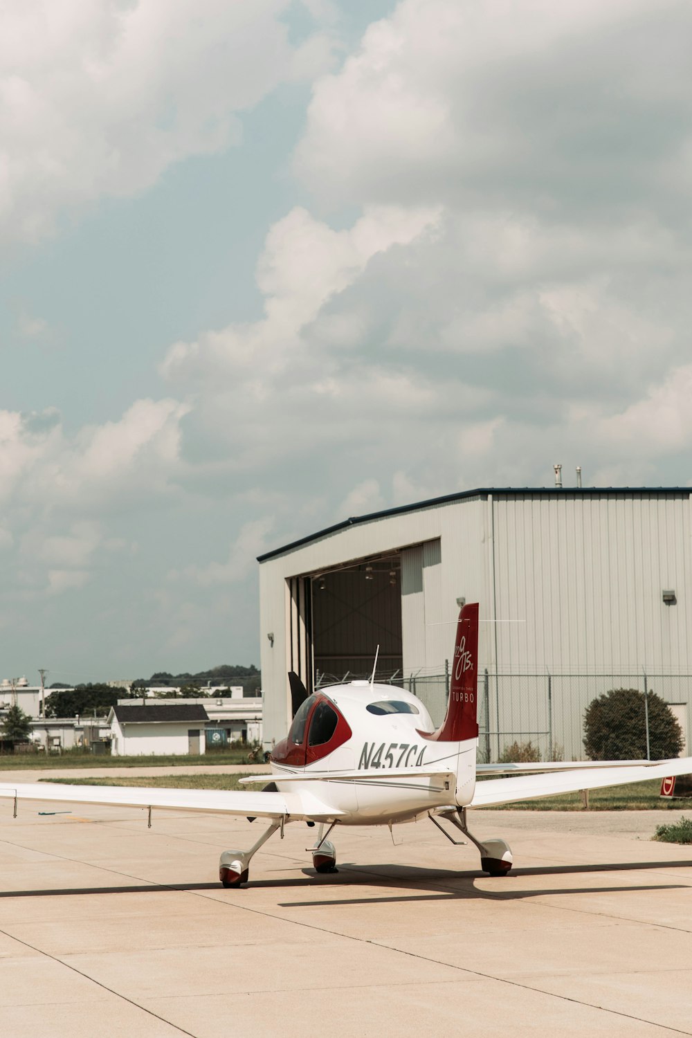 a small airplane parked in front of a hangar