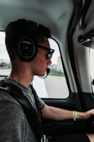 Pilot using voice commands with First Officer through a headset inside a cockpit.