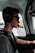 a man wearing headphones sitting in a car
