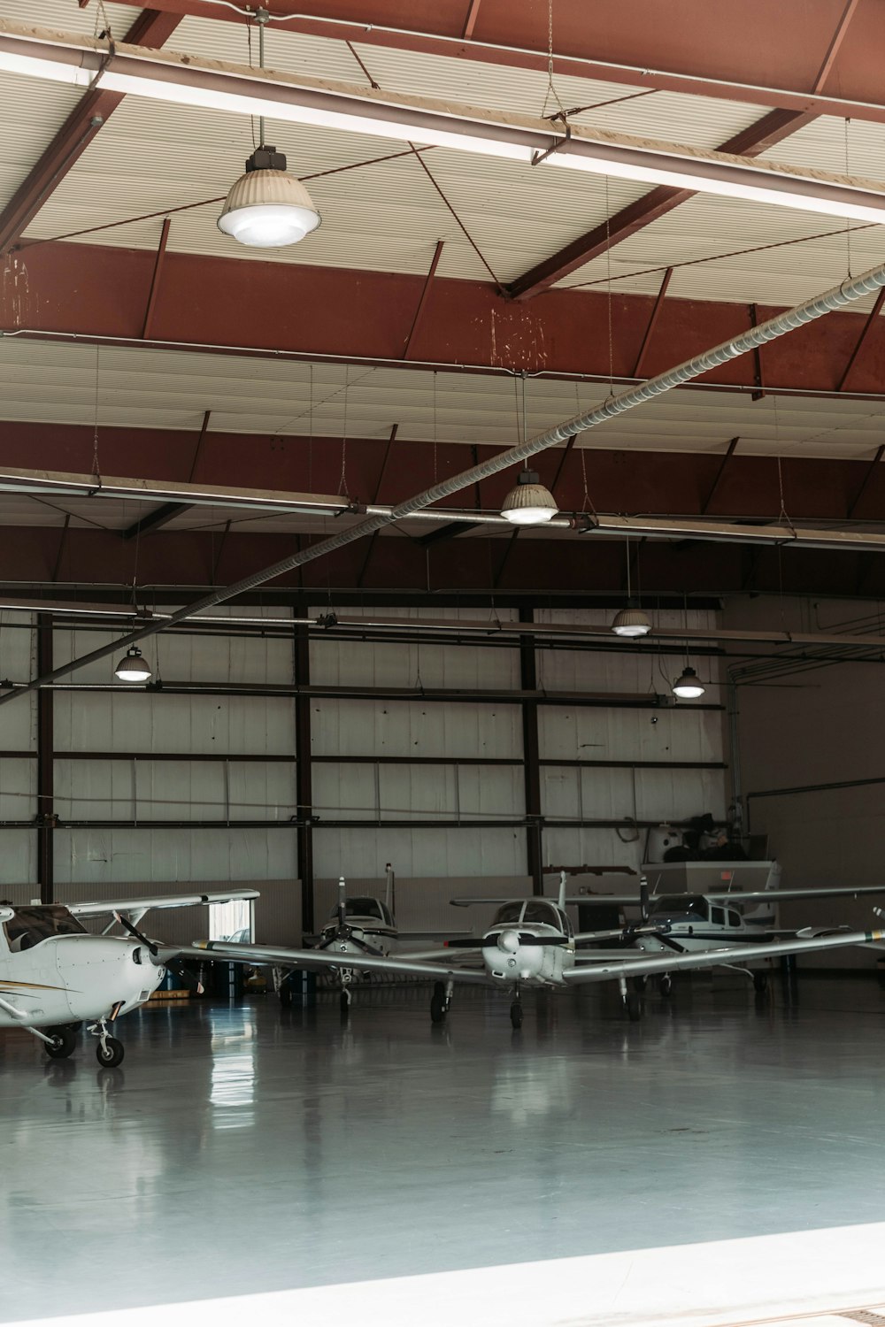 two airplanes are parked in a large hanger