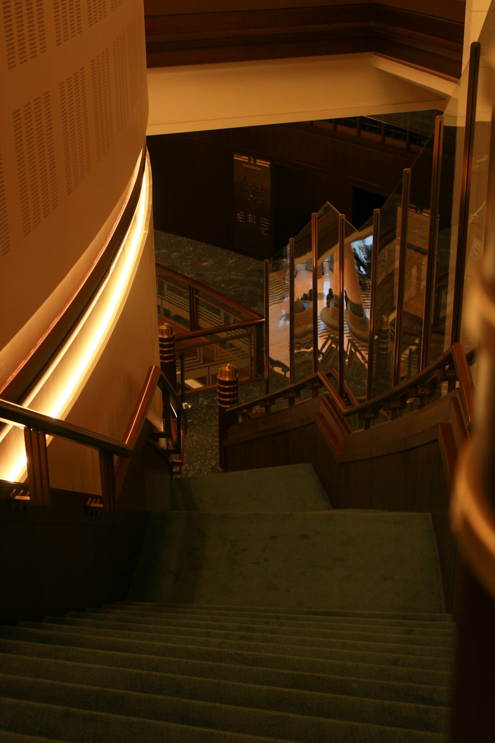 a view of a staircase from the top of a flight of stairs