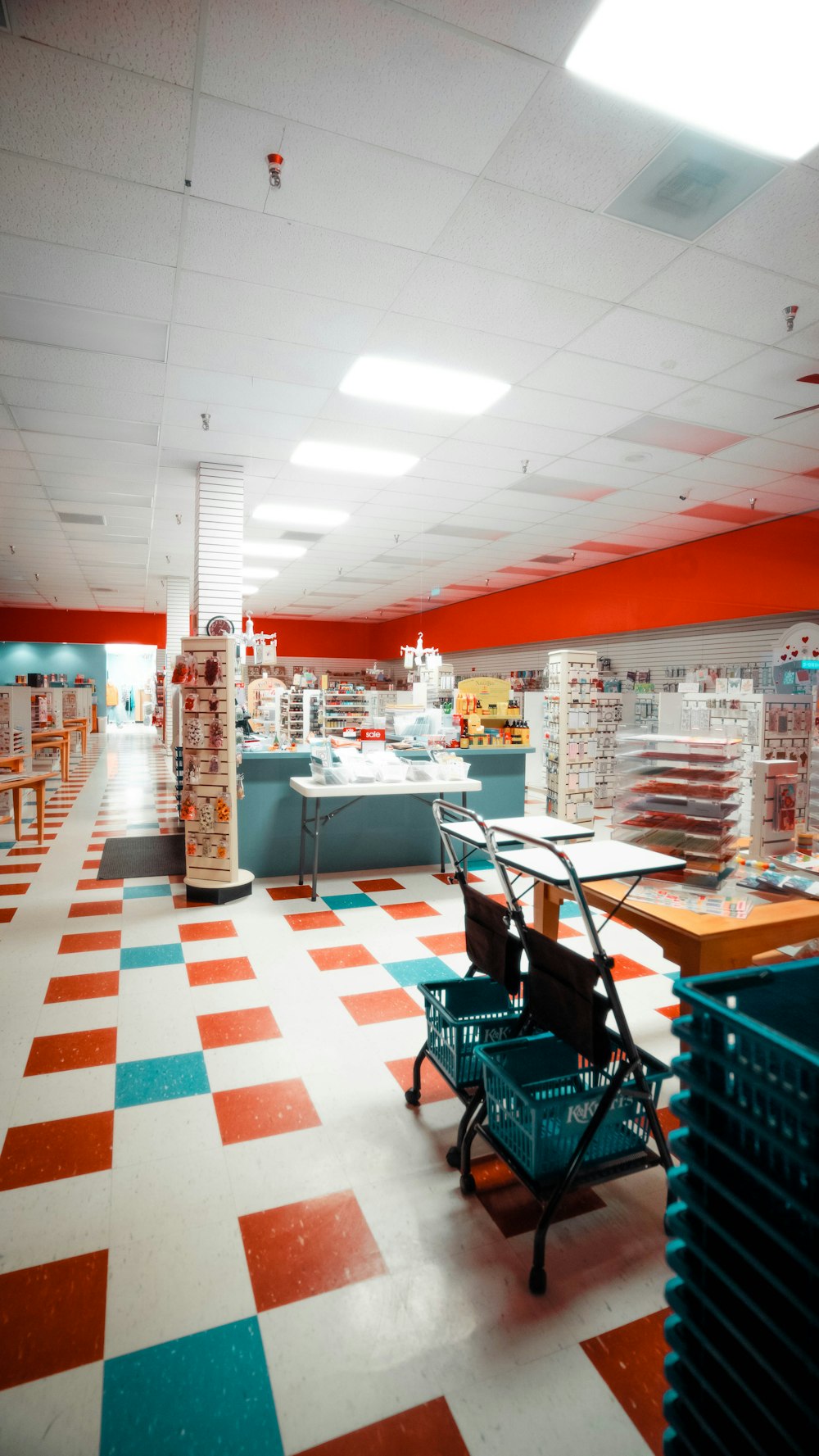 a checkered floor in a store with a shopping cart