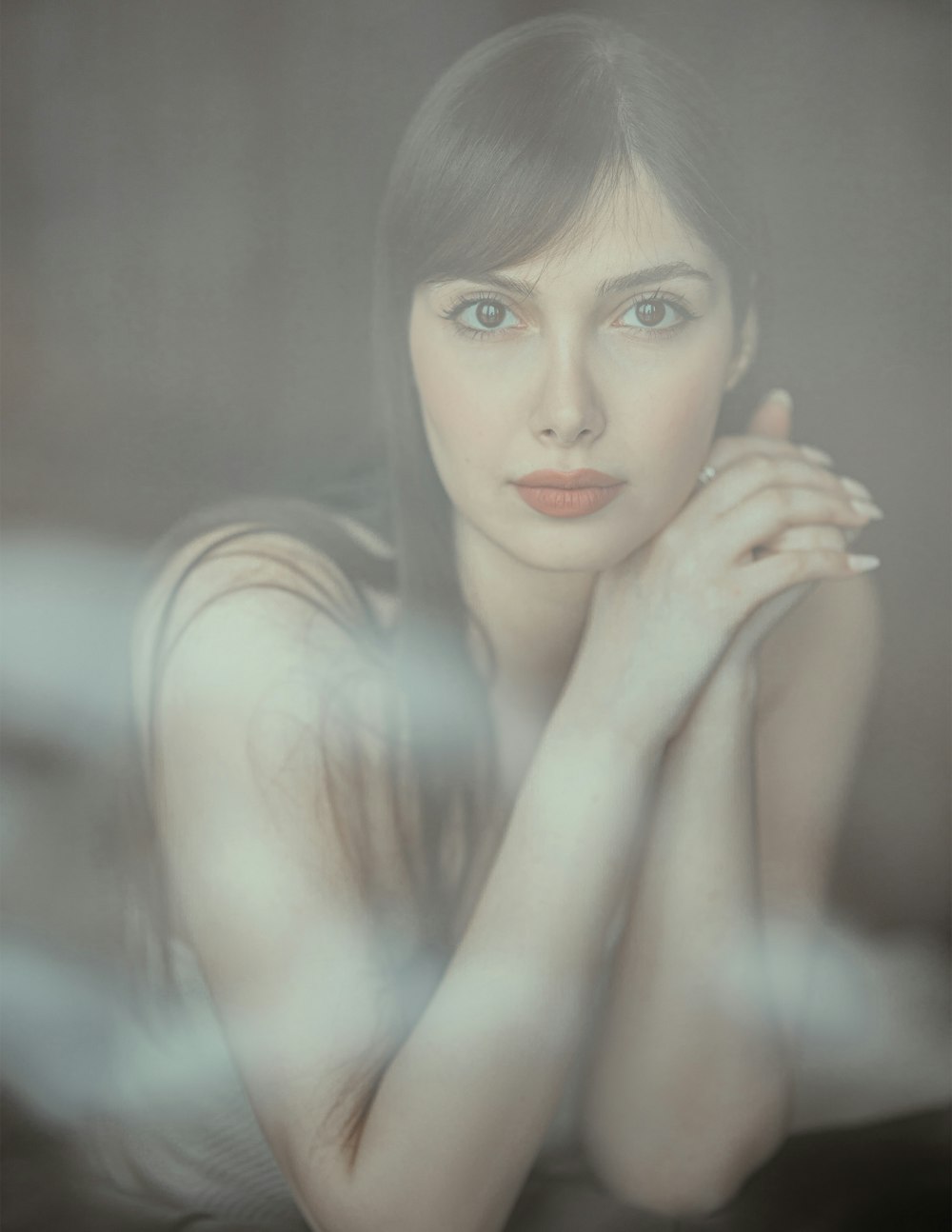 a woman is posing for a picture with her hands on her chest