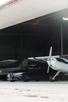 A hangar with a private aircraft parked in front.