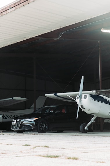 A sleek private jet parked in a pristine hangar, gleaming under soft lighting.