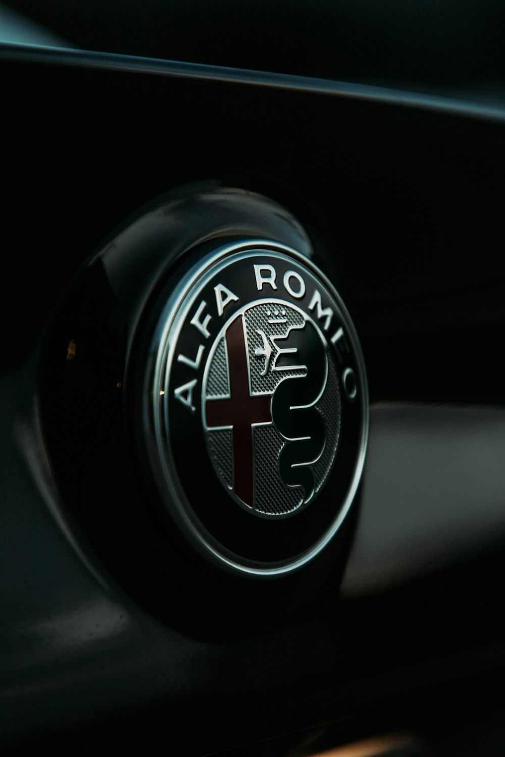the alfa logo on the front of a car