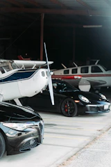 An interview setting with a collector surrounded by cars and a private plane.