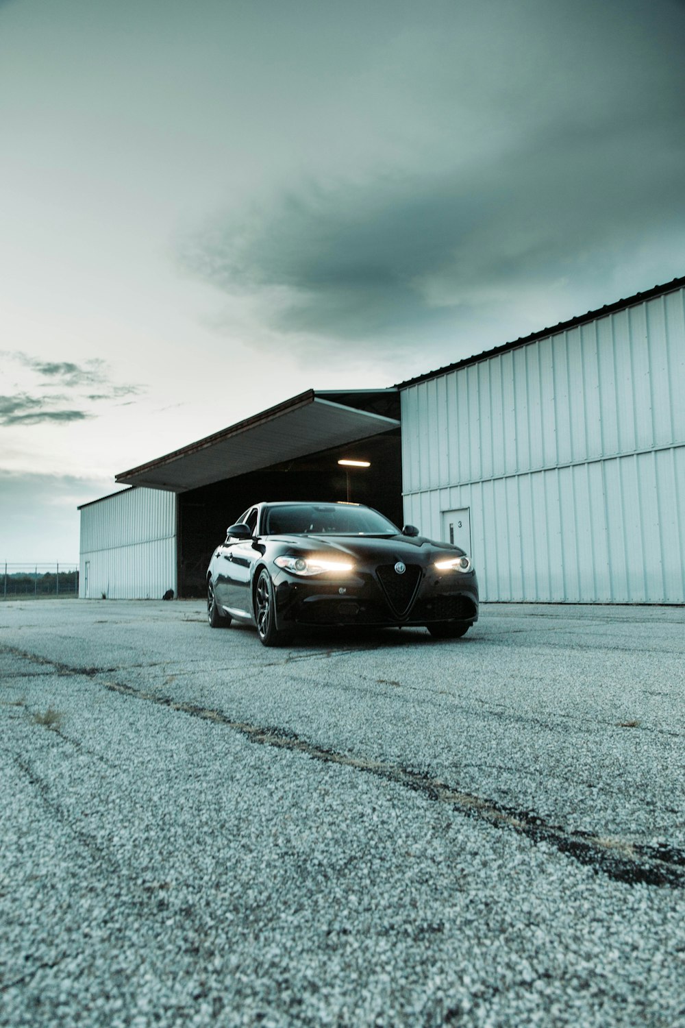 a black car parked in front of a building