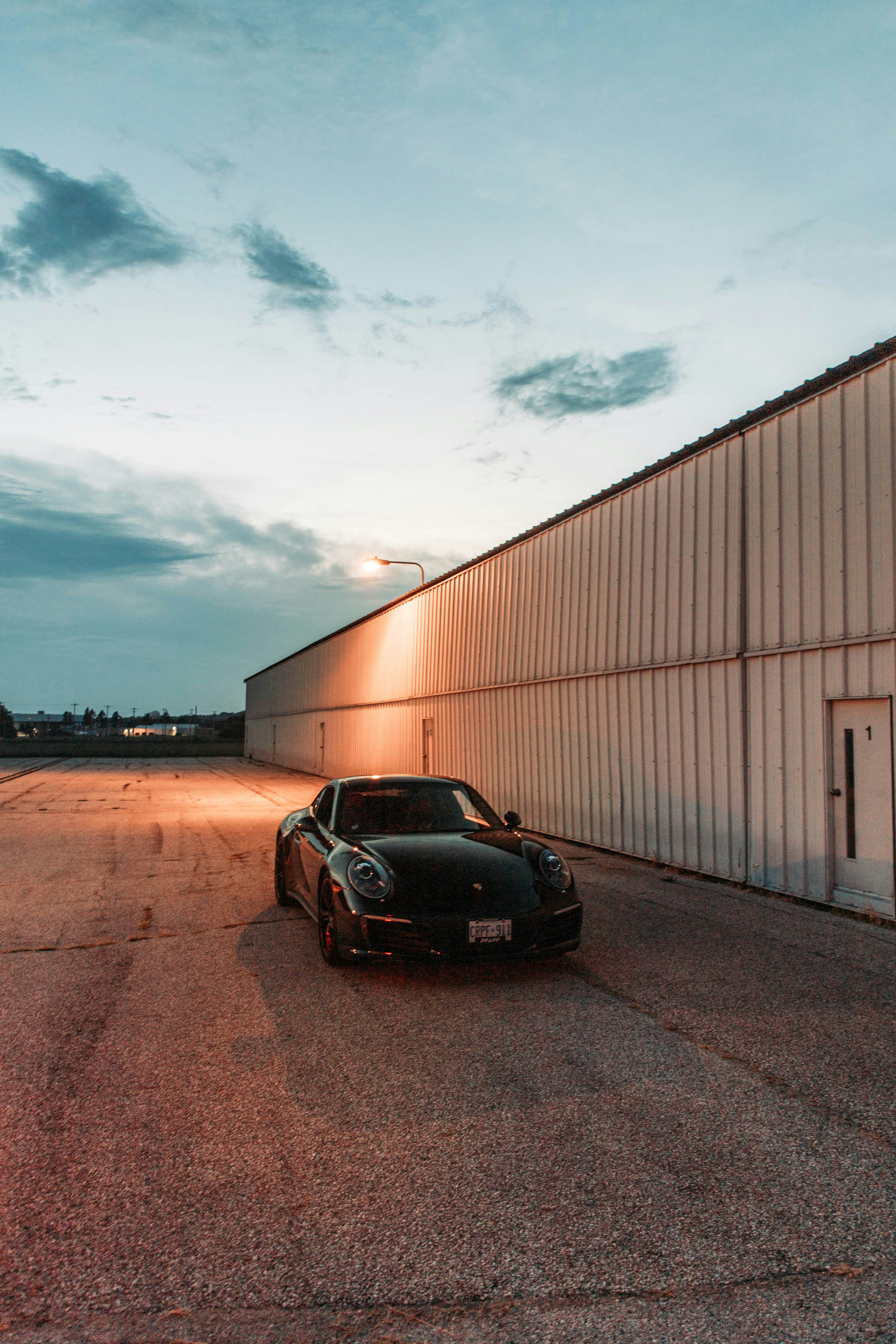 a black sports car parked in front of a building