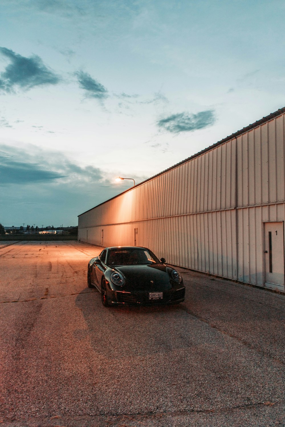 a black sports car parked in front of a building