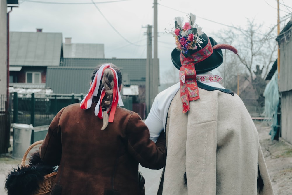 a couple of people that are walking down a street