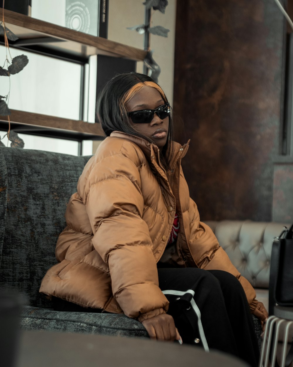 a woman sitting on a couch in a room