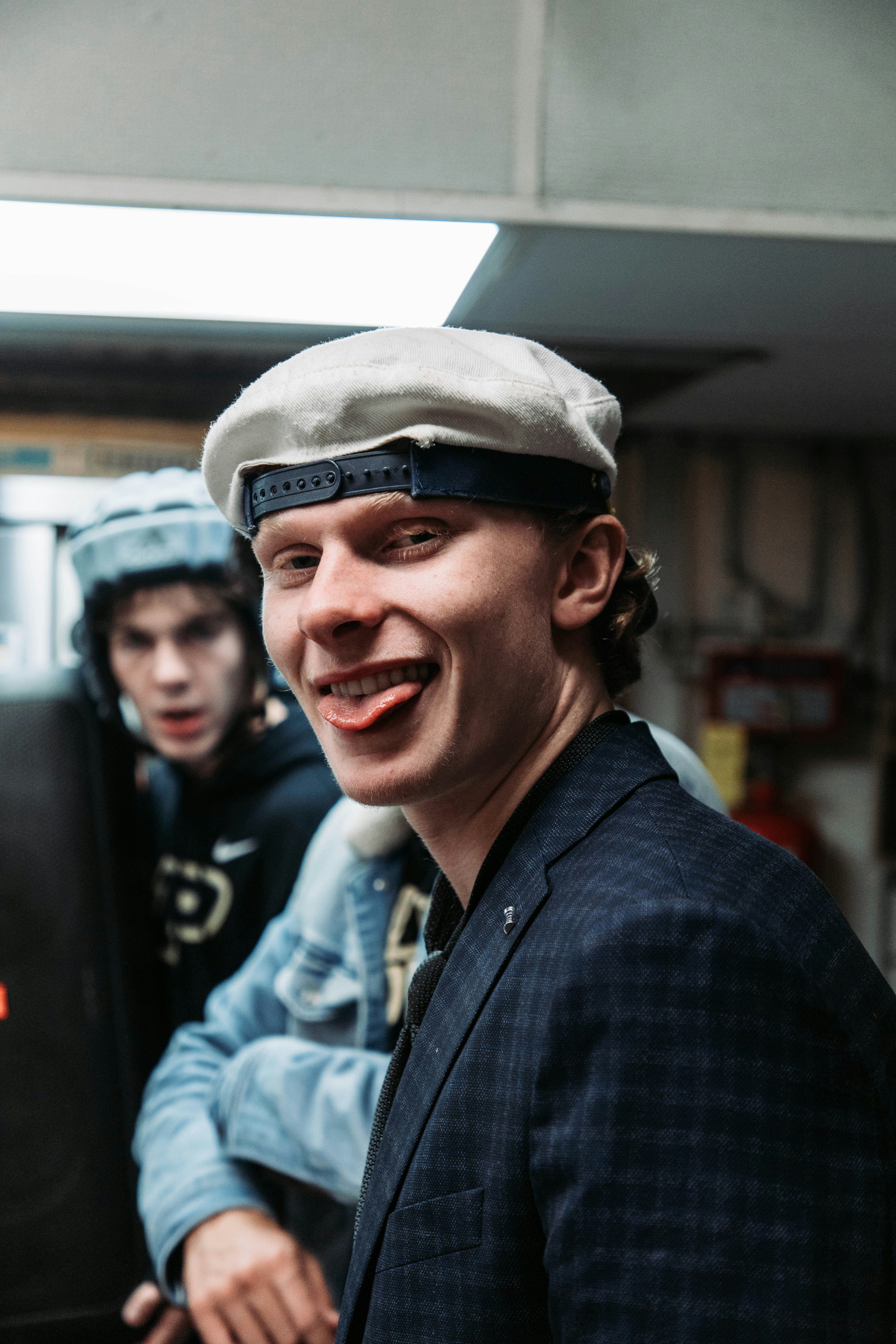 a man wearing a hat and smiling at the camera