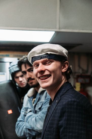 A lively photo of the four Beniwal brothers laughing together, each wearing their signature 'bta tu ab' hoodie.
