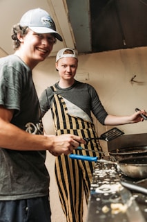 a man and a woman cooking in a kitchen