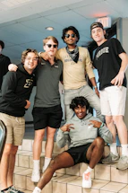 A warm gathering of international students sharing smiles on the Purdue campus.