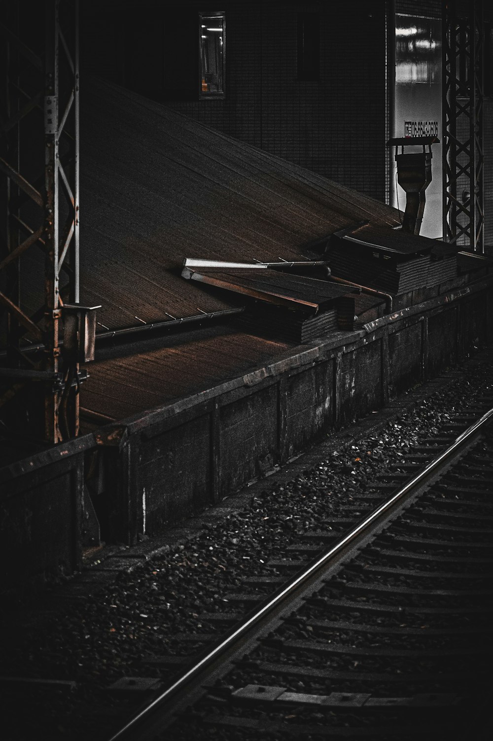 a person standing on a train track in the dark