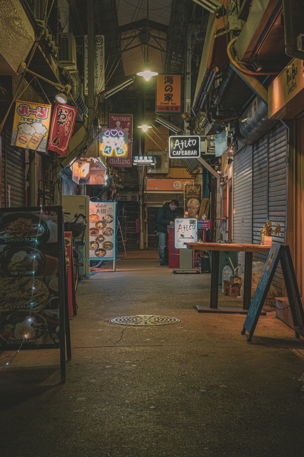 a narrow alley with signs and signs on the walls