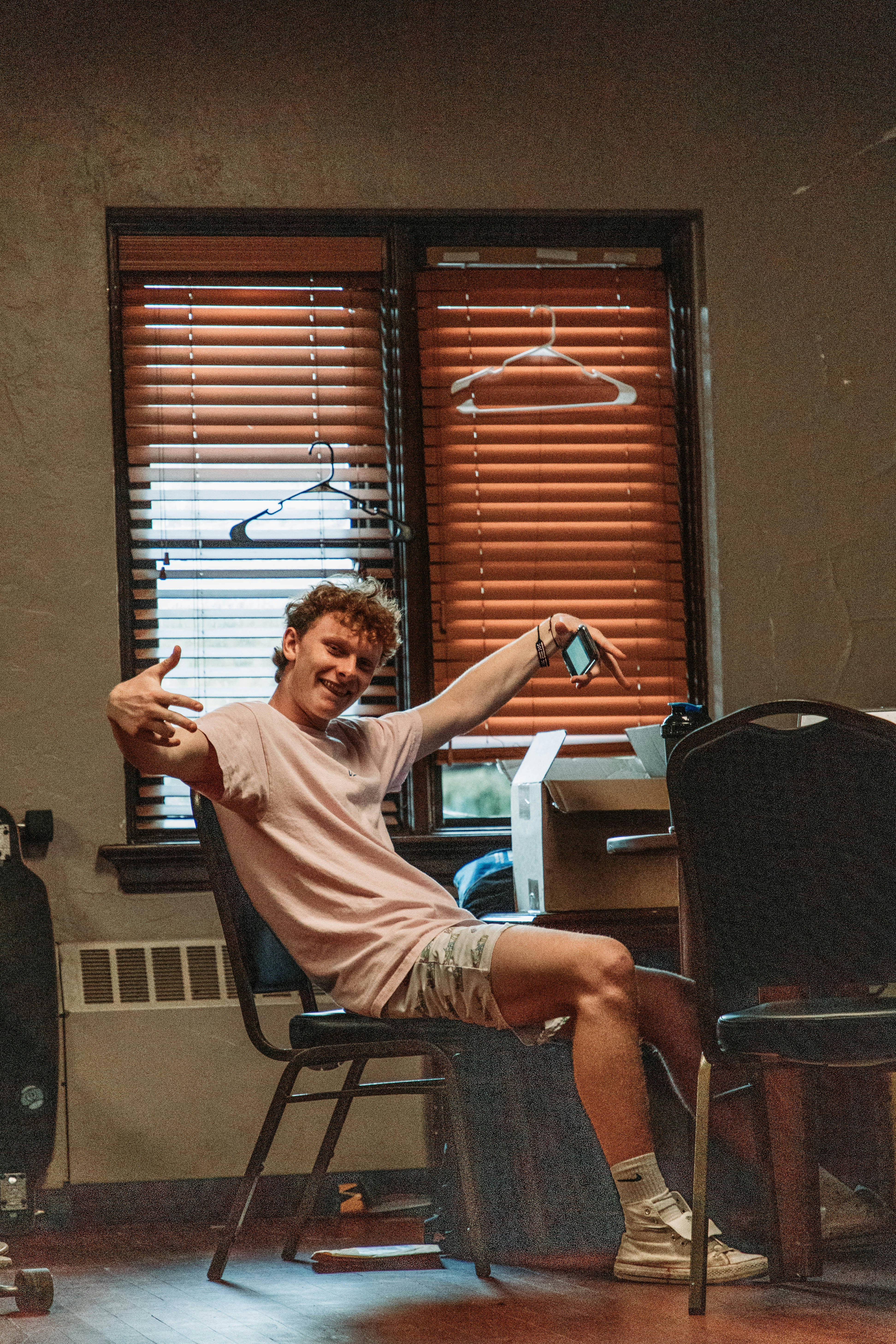 a man sitting in a chair with his arm up