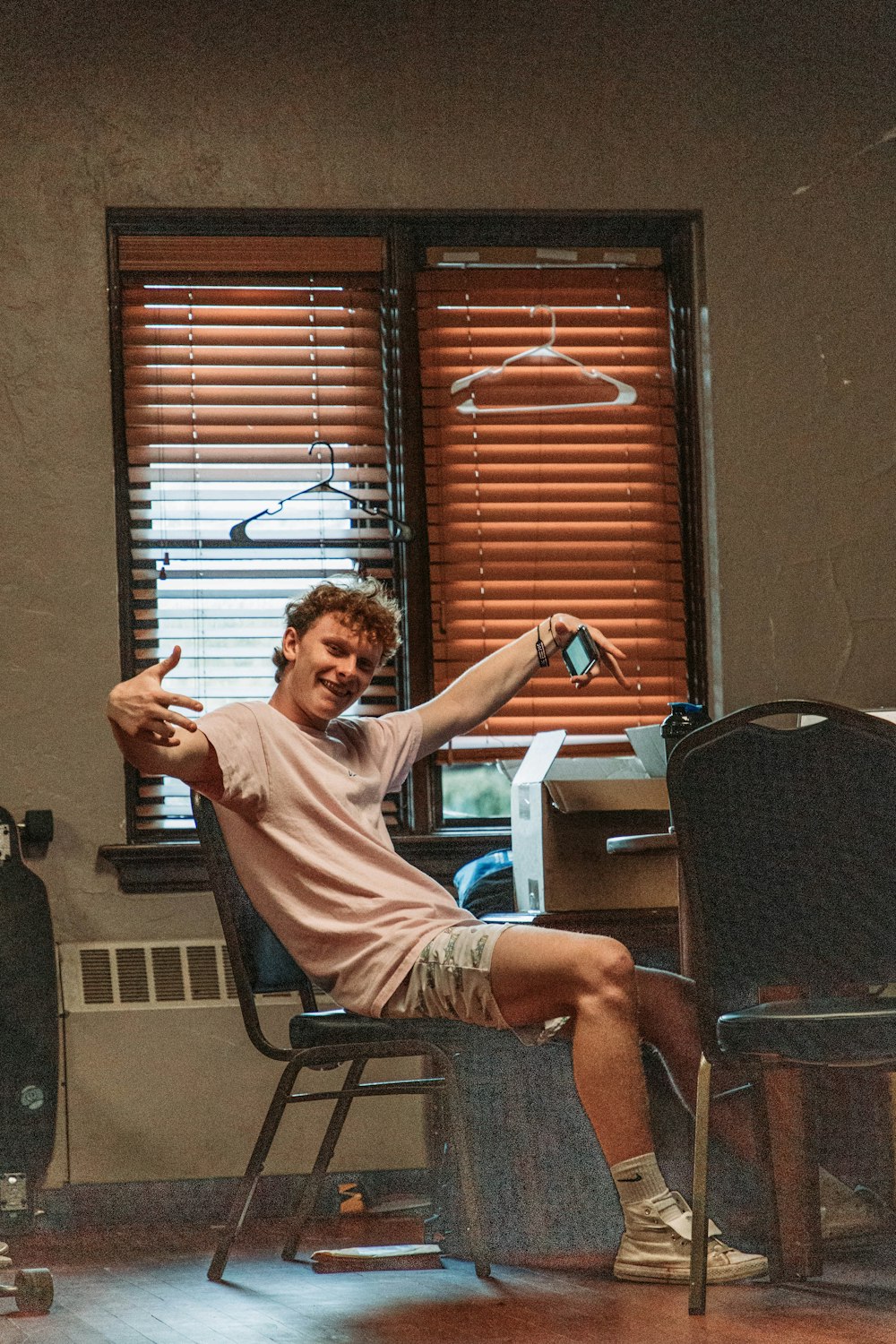 a man sitting in a chair with his arm up