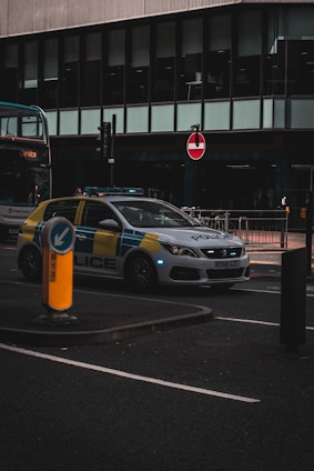 a police car parked next to a double decker bus