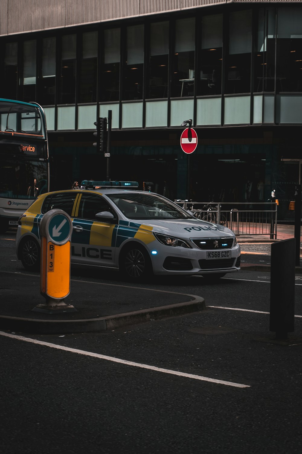 a police car parked next to a double decker bus