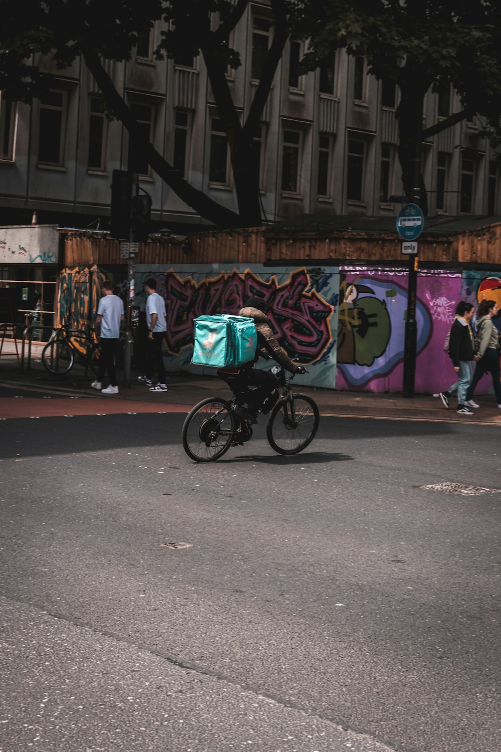 a person riding a bike on a city street