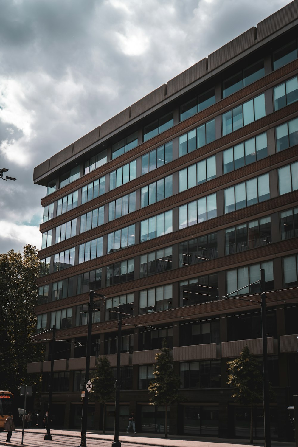 a tall building with lots of windows next to a street