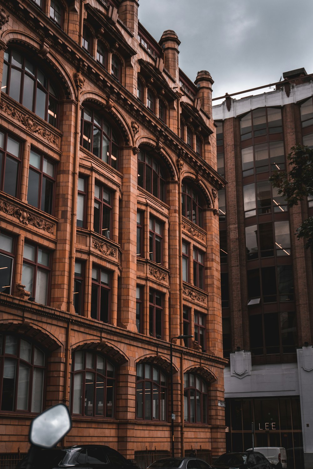 a motorcycle parked in front of a tall building