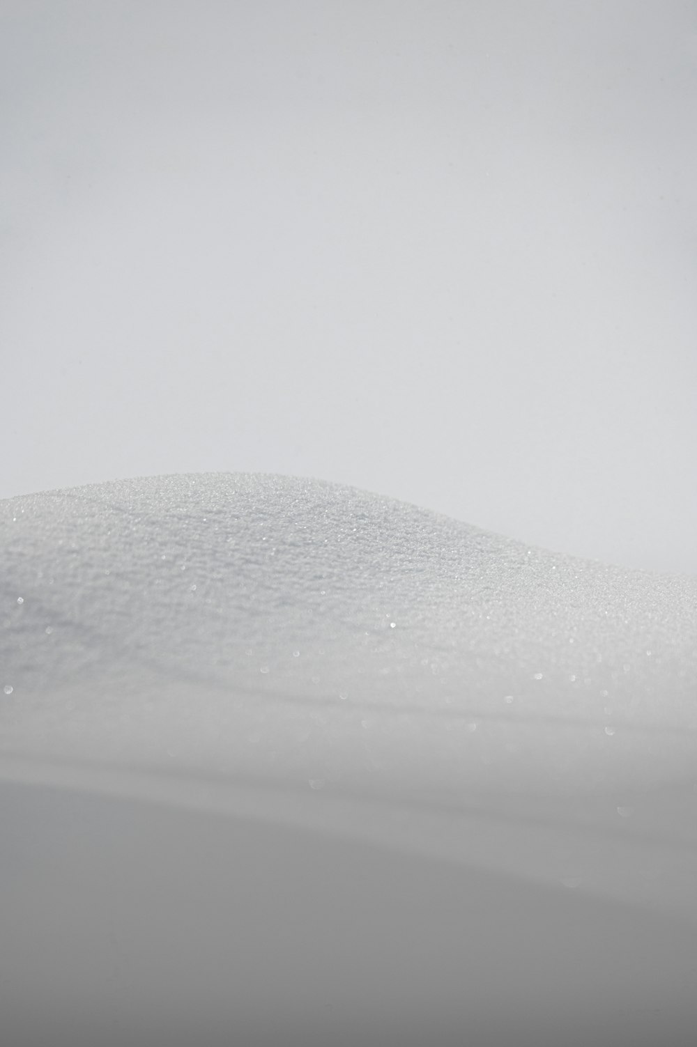 a person riding skis down a snow covered slope