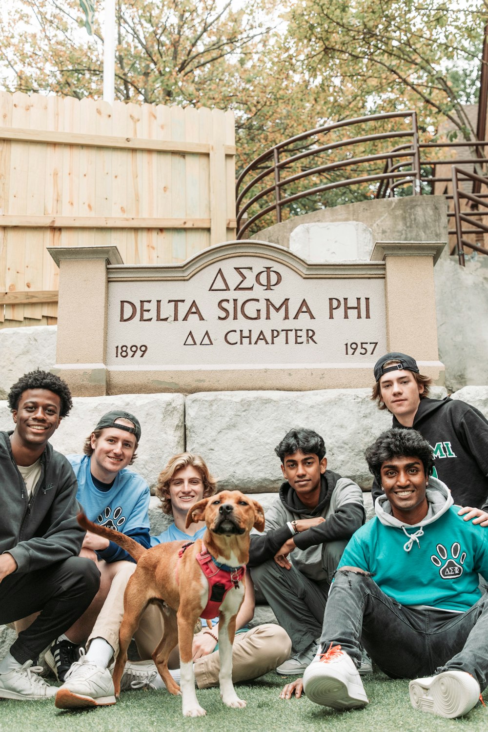 a group of people sitting next to a dog