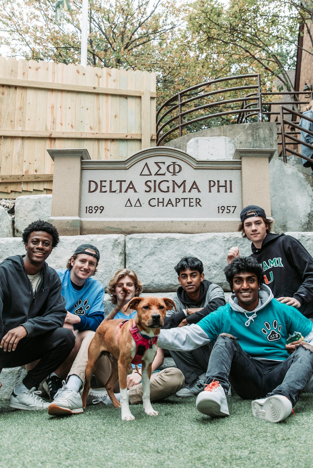 a group of people and a dog posing for a picture