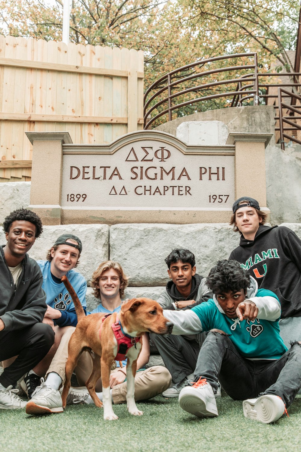 a group of people posing for a picture with a dog