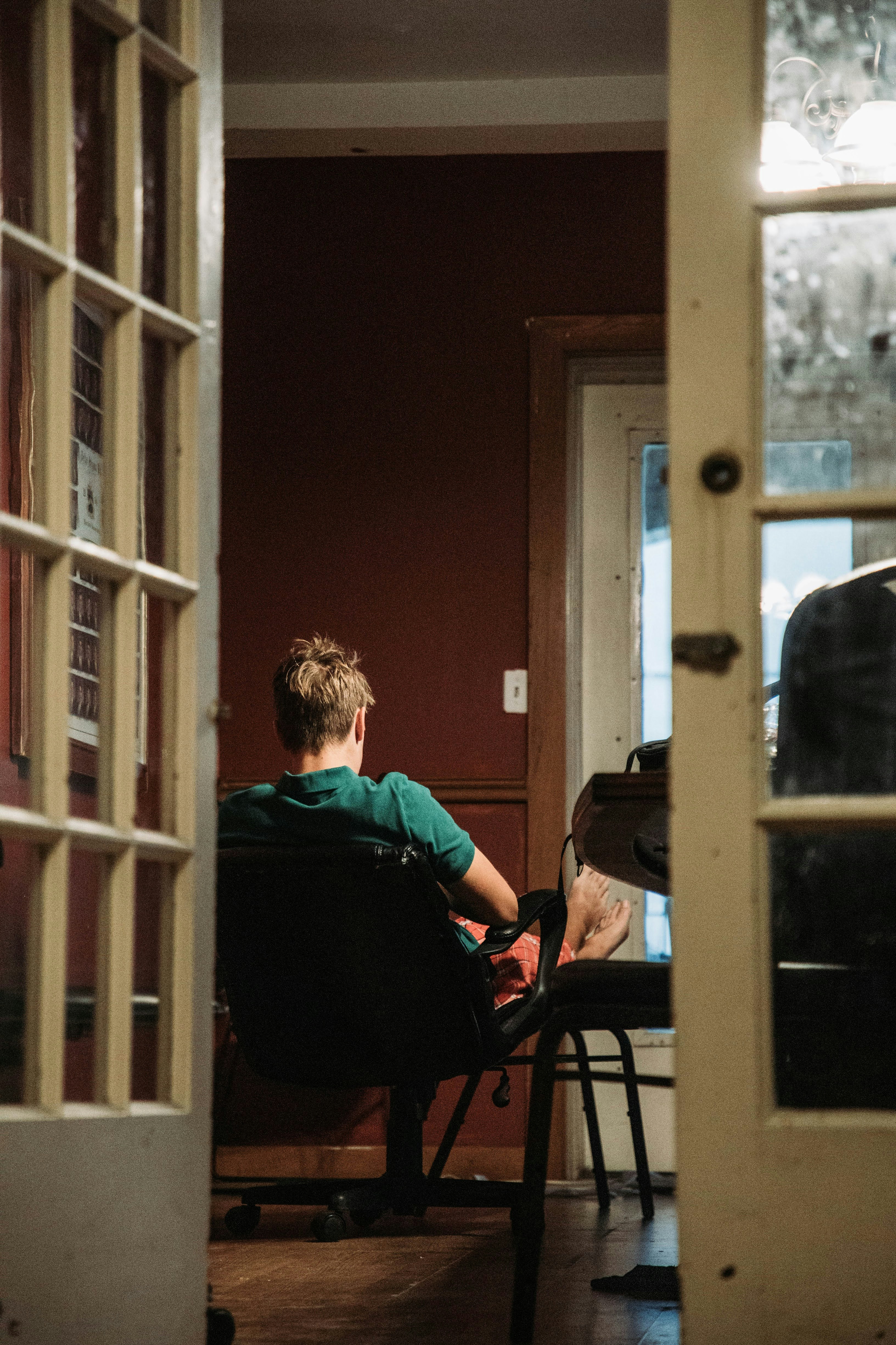 a boy sitting in a chair in a room