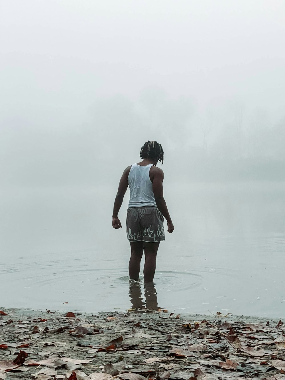 a person standing in the water with a frisbee