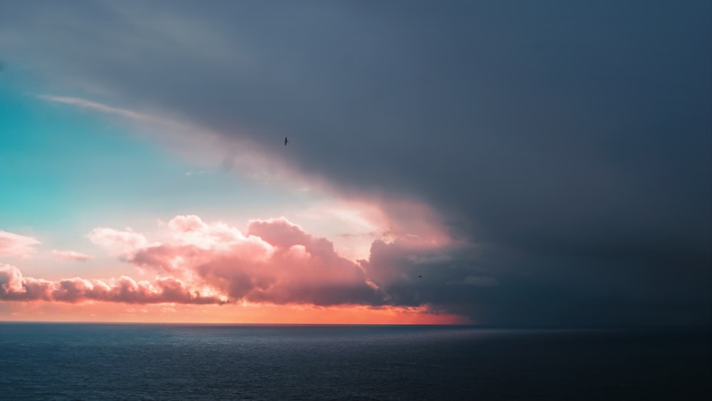 the sun is shining through the clouds over the ocean